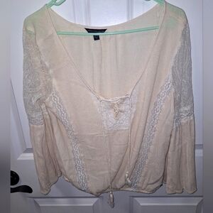 An American Eagle sheer and lace low-cut blouse in a size medium.